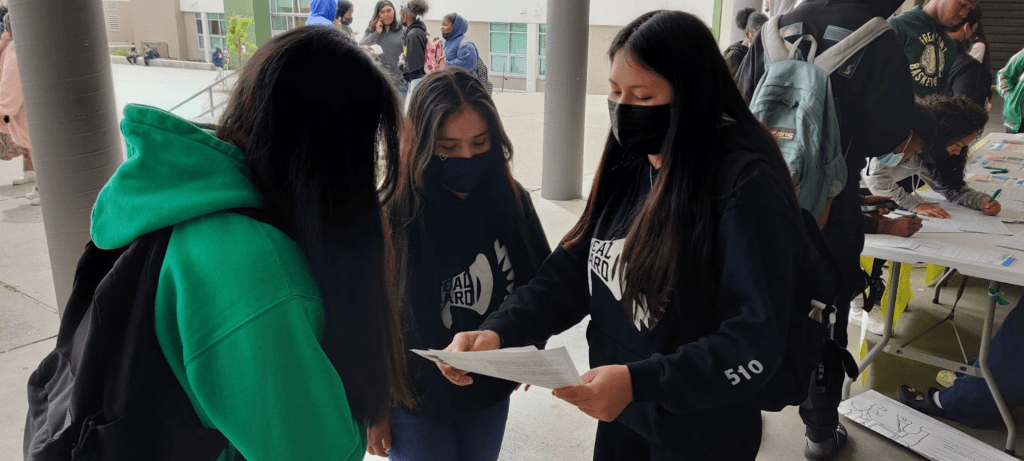 Two youth leaders talking to another young person