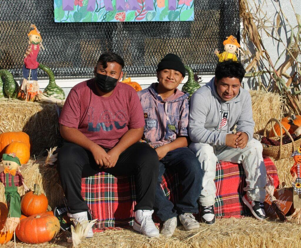 Three happy youths posing for a photo