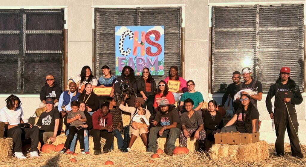 Students in front of a building with a sign that says 